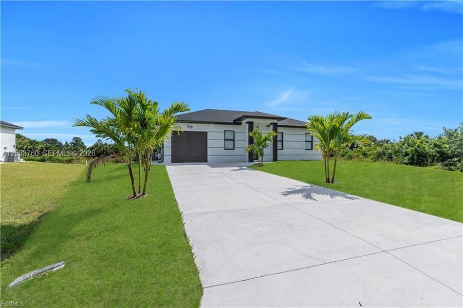 Front exterior of a new home in , Lehigh Acres, FL, highlighting curb appeal (Image 17).