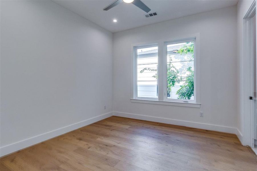 Spare room featuring light wood-type flooring and ceiling fan