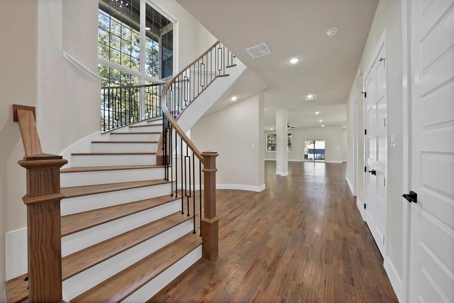 Staircase with recessed lighting and wood finished floors Staircase with recessed lighting and wood finished floors