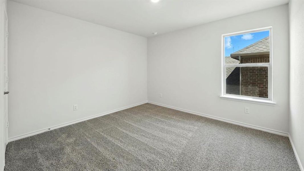 Unfurnished room featuring carpet floors and baseboards