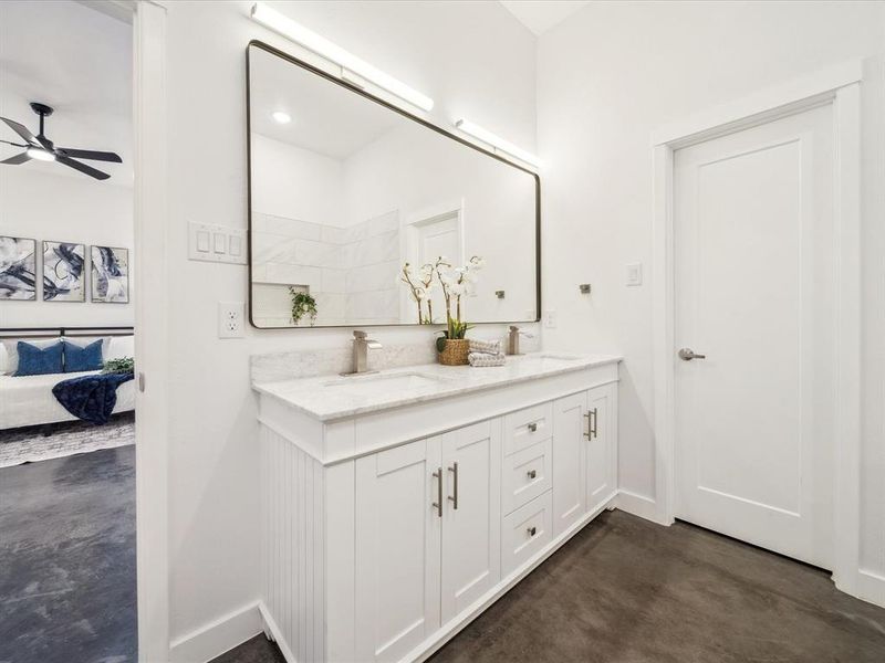 Bathroom with ceiling fan, concrete floors, and vanity