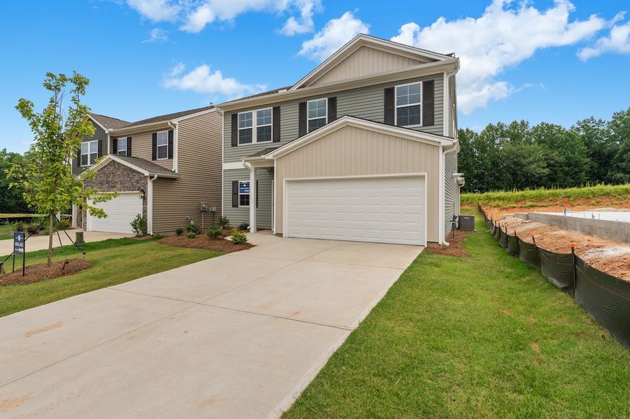 Front exterior of a new home in Richmond Hill, Inman, SC, highlighting curb appeal (Image 2). Front exterior of a new home in Richmond Hill, Inman, SC, highlighting curb appeal (Image 2).
