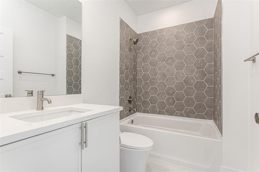Bathroom with vanity, toilet, and  shower combination