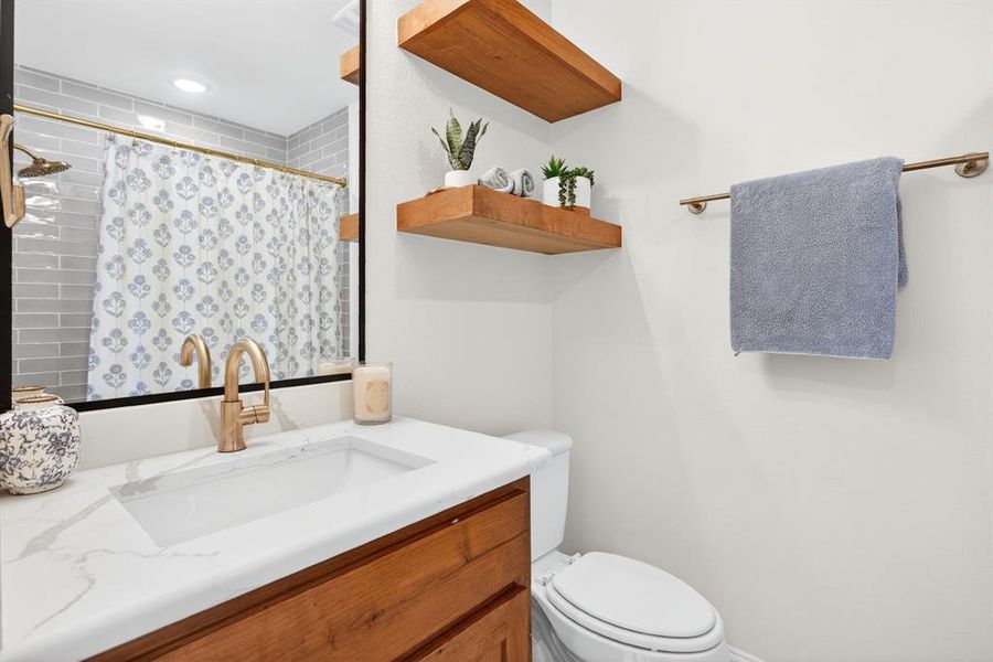 Bathroom with vanity and a shower with shower curtain Bathroom with vanity and a shower with shower curtain