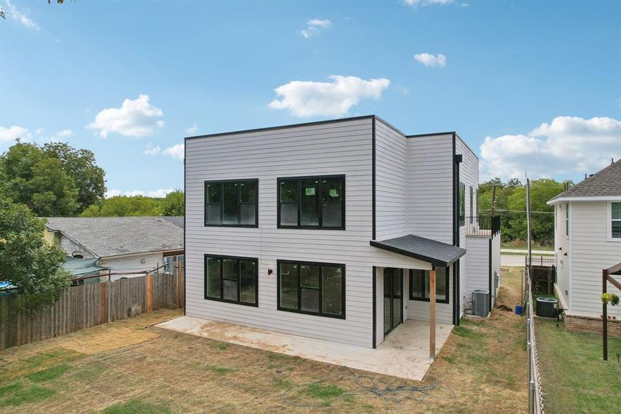 Back of property featuring a patio, a yard, and cooling unit