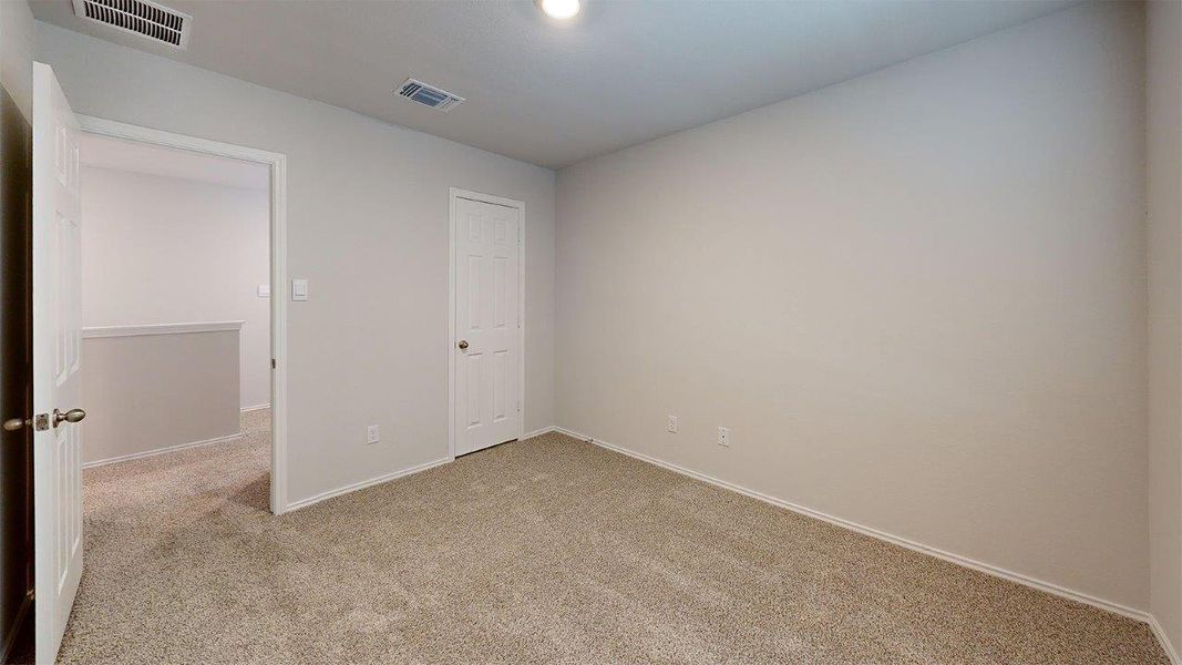 Carpeted room featuring light gray walls and white trim Carpeted room featuring light gray walls and white trim