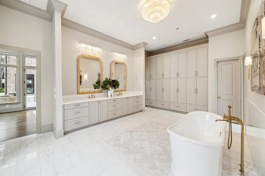 Just WOW! This bathroom is the pinnacle of luxury and design. From the dazzling chandelier to the freestanding tub, gold accents, and ample storage, every element is flawlessly crafted.