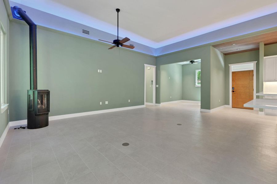 The living area features a freestanding wood-burning stove, designed for cozy gatherings.