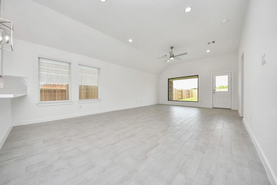 Gather the family and guests together in your lovely living room! Featuring soaring high ceilings, recessed lighting, ceiling fan, custom paint, gorgeous floors, and large windows that provide plenty of natural lighting throughout the day. Sample photo of completed home with similar floor plan. Actual colors and selections may vary. Gather the family and guests together in your lovely living room! Featuring soaring high ceilings, recessed lighting, ceiling fan, custom paint, gorgeous floors, and large windows that provide plenty of natural lighting throughout the day. Sample photo of completed home with similar floor plan. Actual colors and selections may vary.