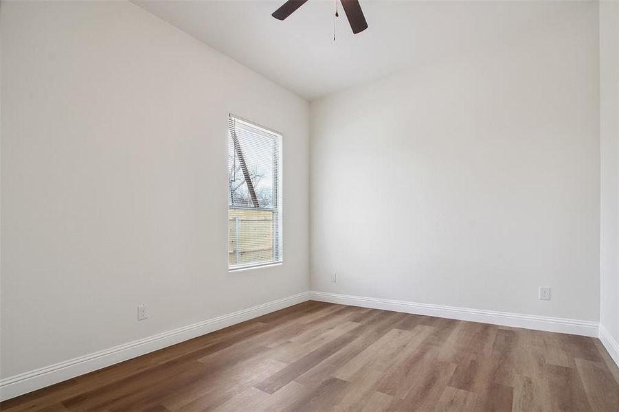 Unfurnished room featuring ceiling fan and light wood-type flooring