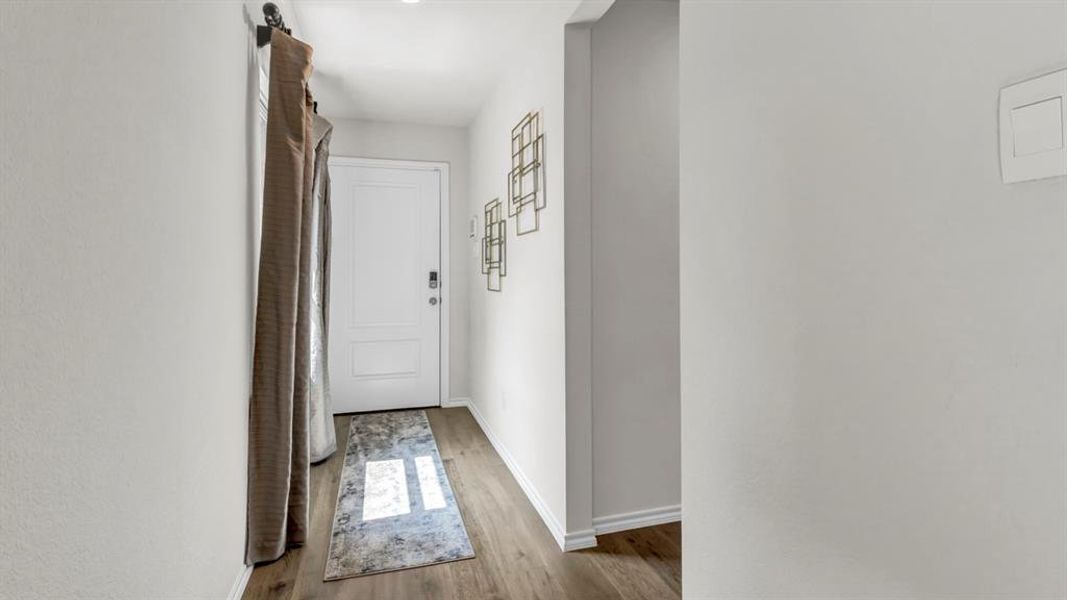 Entryway with baseboards and wood finished floors Entryway with baseboards and wood finished floors
