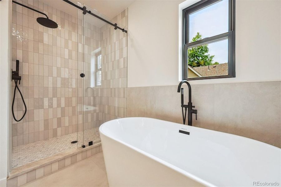 Soaking tub and large walk in shower are perfect relaxing spaces in the primary bath