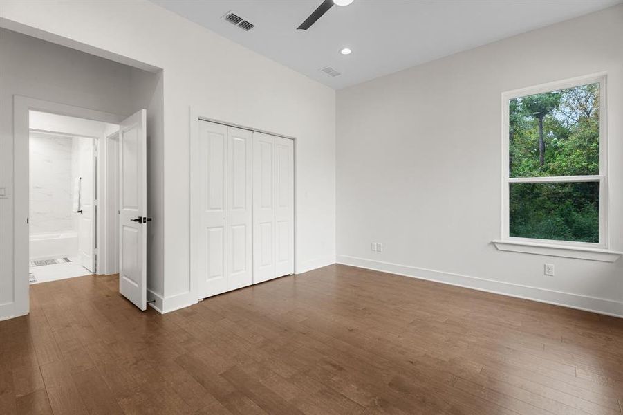 Unfurnished bedroom with a closet, dark wood-type flooring, and ceiling fan Unfurnished bedroom with a closet, dark wood-type flooring, and ceiling fan