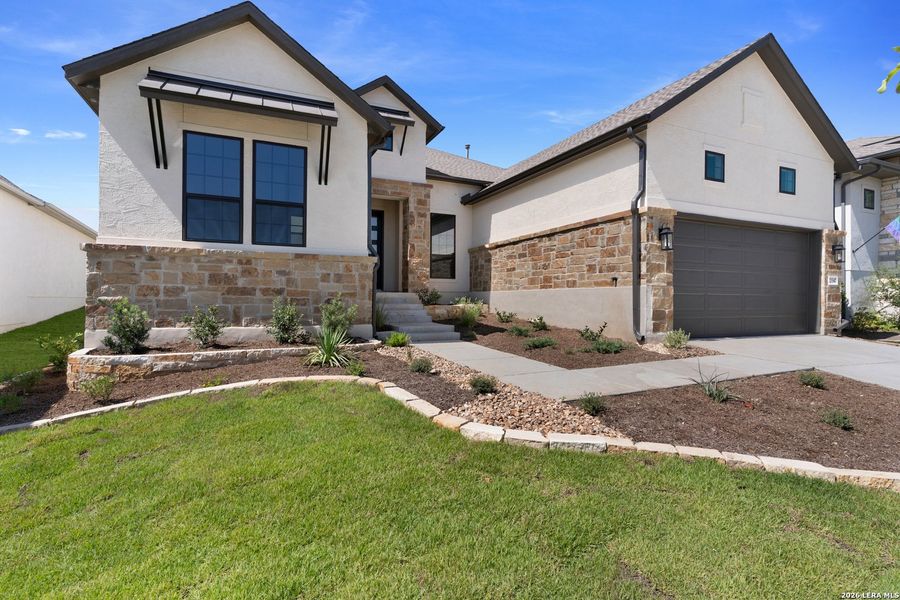 Front exterior of a new home in El Sonido at Campanas, San Antonio, TX, highlighting curb appeal (Image 2).