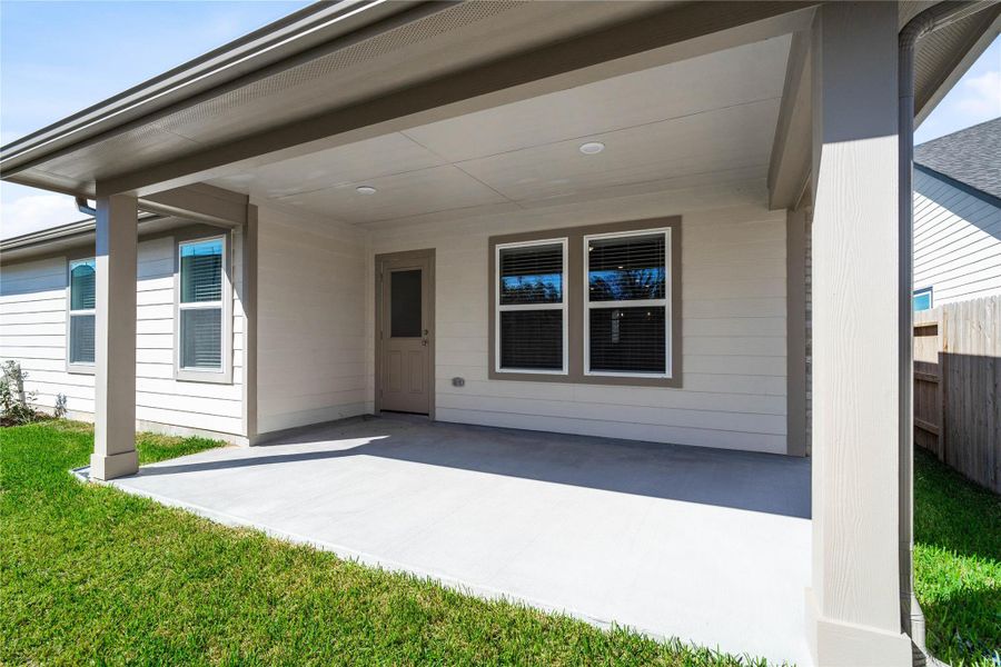 The spacious covered patio offers a tranquil outdoor retreat, perfectly designed for savoring your quiet morning coffee or unwinding during peaceful evening relaxation.