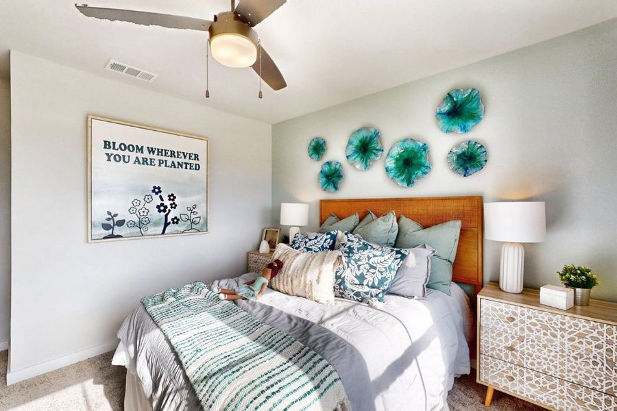 A bedroom with a bed and a fan.