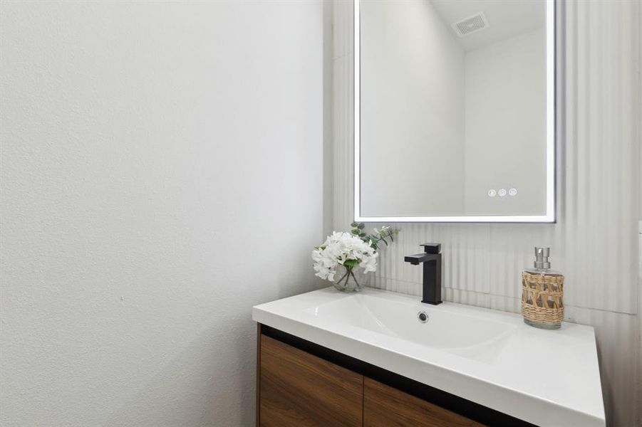 1st floor powder room with floating vanity, LED mirror and fluted backsplash