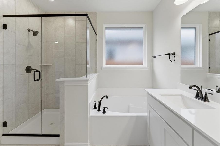 Contemporary bathroom featuring a frameless glass shower enclosure with dark bronze fixtures, a built-in bathtub, and a single vanity with a white countertop