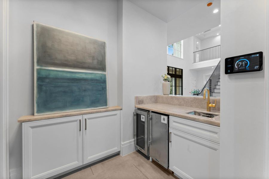 The wet bar includes an ice maker and beverage refrigerator The wet bar includes an ice maker and beverage refrigerator