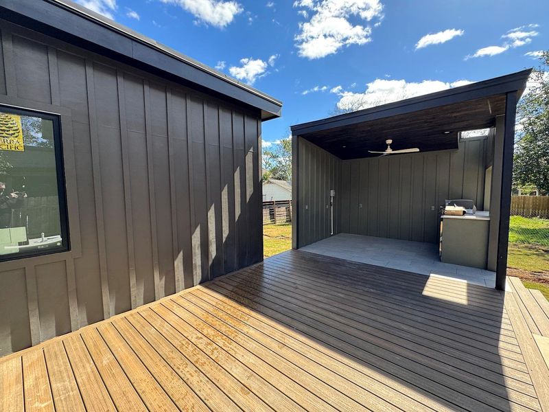 Wooden terrace featuring ceiling fan and fence