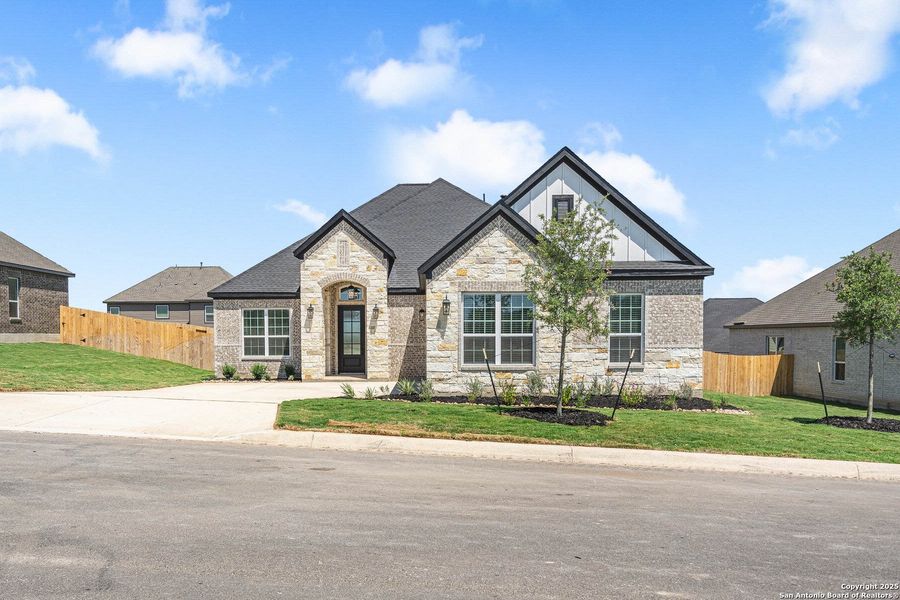 Front exterior of a new home in Potranco West, Castroville, TX, highlighting curb appeal (Image 1). Front exterior of a new home in Potranco West, Castroville, TX, highlighting curb appeal (Image 1).