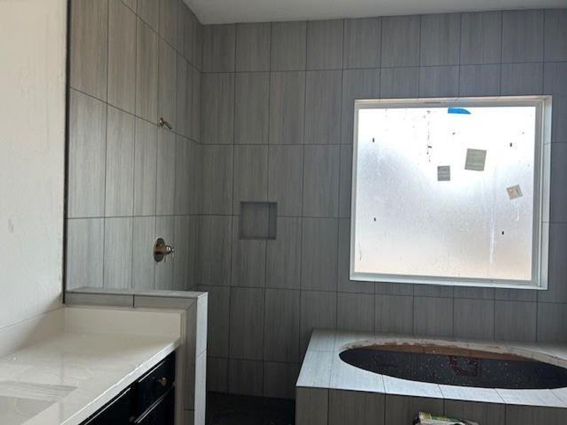 Striking grey tile, floor to ceiling makes a statement.