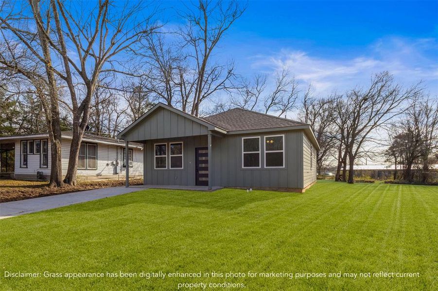 Single story home with a front lawn, board and batten siding, and roof with shingles