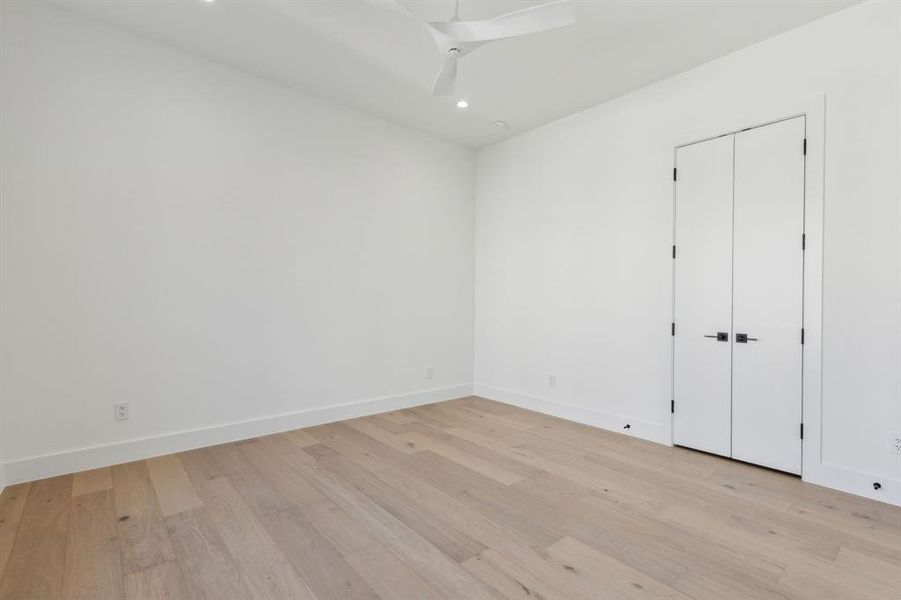 Spare room featuring ceiling fan and light hardwood / wood-style flooring