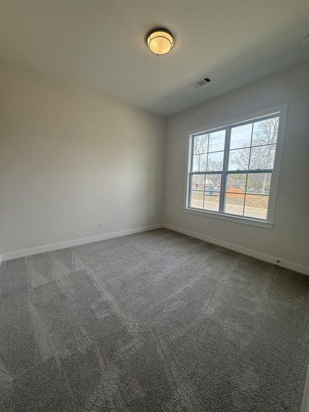 Spare room with carpet and baseboards