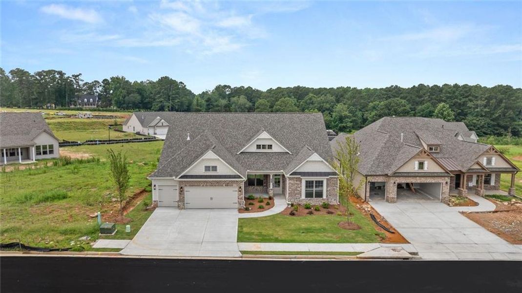 Front exterior of a new home in Soleil Summit Chase, Snellville, GA, highlighting curb appeal (Image 25). Front exterior of a new home in Soleil Summit Chase, Snellville, GA, highlighting curb appeal (Image 25).