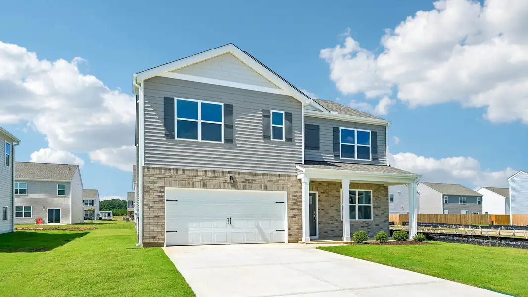 Front exterior of a new home in Shahbain Reserve, Raeford, NC, highlighting curb appeal (Image 22). Front exterior of a new home in Shahbain Reserve, Raeford, NC, highlighting curb appeal (Image 22).