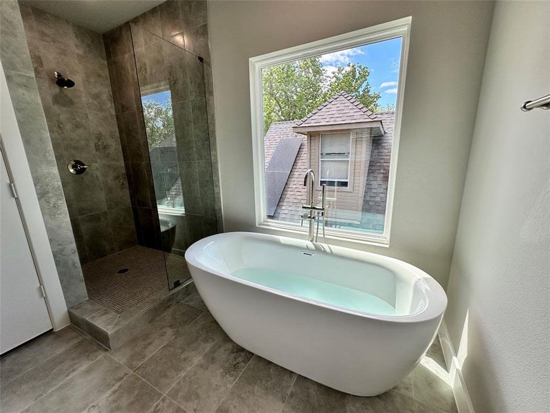 Primary Bathroom with separate shower and tub and tile floors