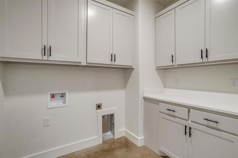 Laundry area with electric dryer hookup, washer hookup, and cabinets