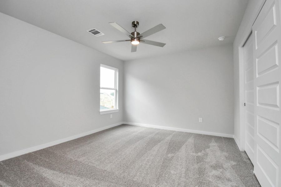 Secondary bedroom features plush carpeting, large windows that let in plenty of natural light, bright paint, and spacious closets. Secondary bedroom features plush carpeting, large windows that let in plenty of natural light, bright paint, and spacious closets.