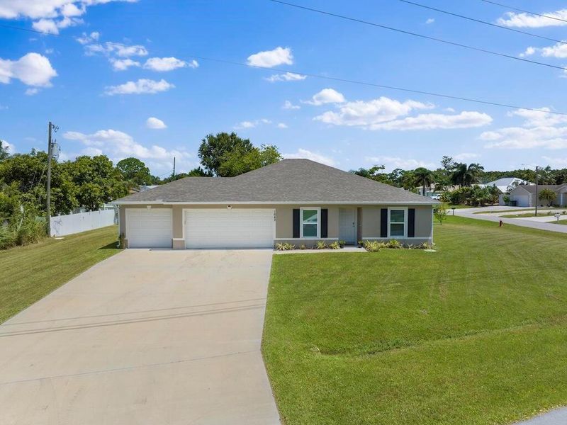 Front exterior of a new home in , Port St. Lucie, FL, highlighting curb appeal (Image 1).