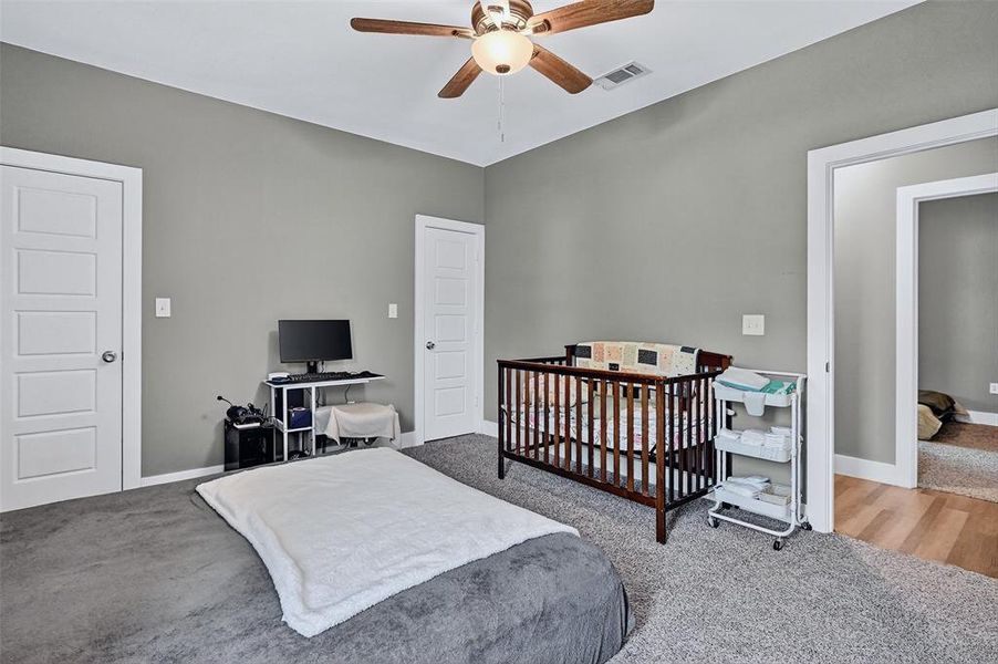 Carpeted bedroom featuring baseboards and a ceiling fan Carpeted bedroom featuring baseboards and a ceiling fan