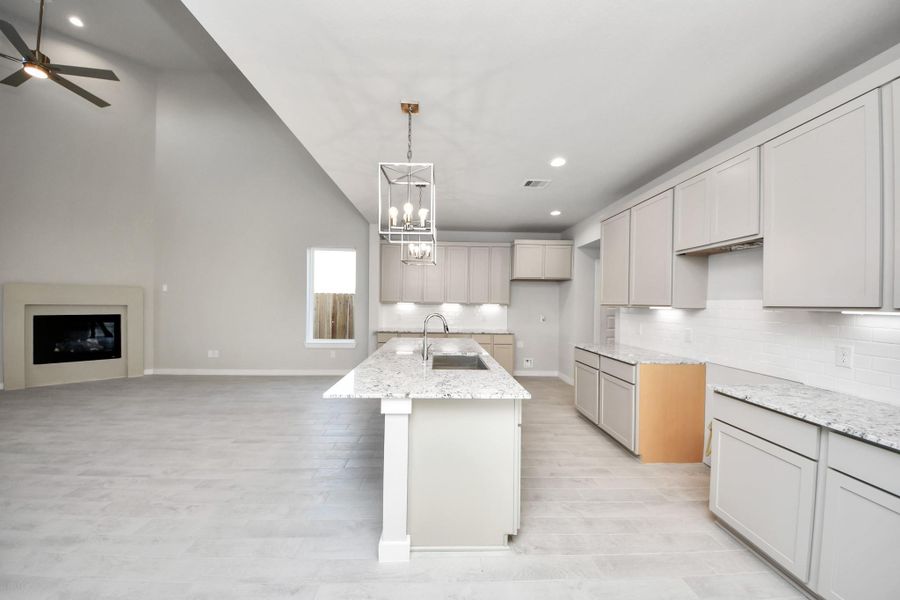 This kitchen is by far any chef’s dream! This spacious kitchen features high ceilings, light stained wood cabinets, granite countertop, SS appliances, modern tile backsplash, recessed lighting, extended counter space, granite kitchen island with double sink, and space for breakfast bar, and a walk-in pantry all overlooking your huge family room. Sample photo of completed home with similar floor plan. Actual colors and selections may vary.