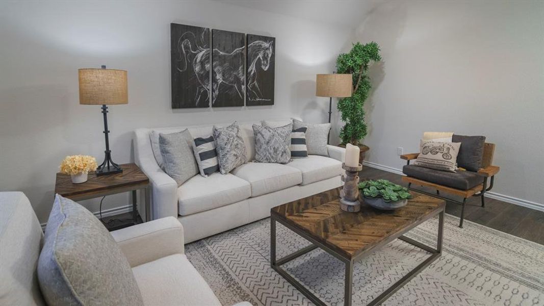 Living area with wood finished floors and baseboards