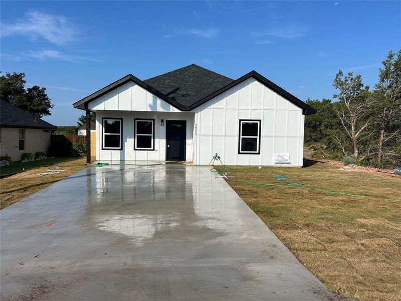 Modern inspired farmhouse with a front lawn