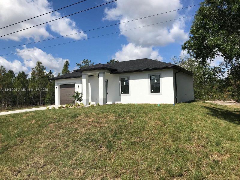 Front exterior of a new home in , Lehigh Acres, FL, highlighting curb appeal (Image 2). Front exterior of a new home in , Lehigh Acres, FL, highlighting curb appeal (Image 2).