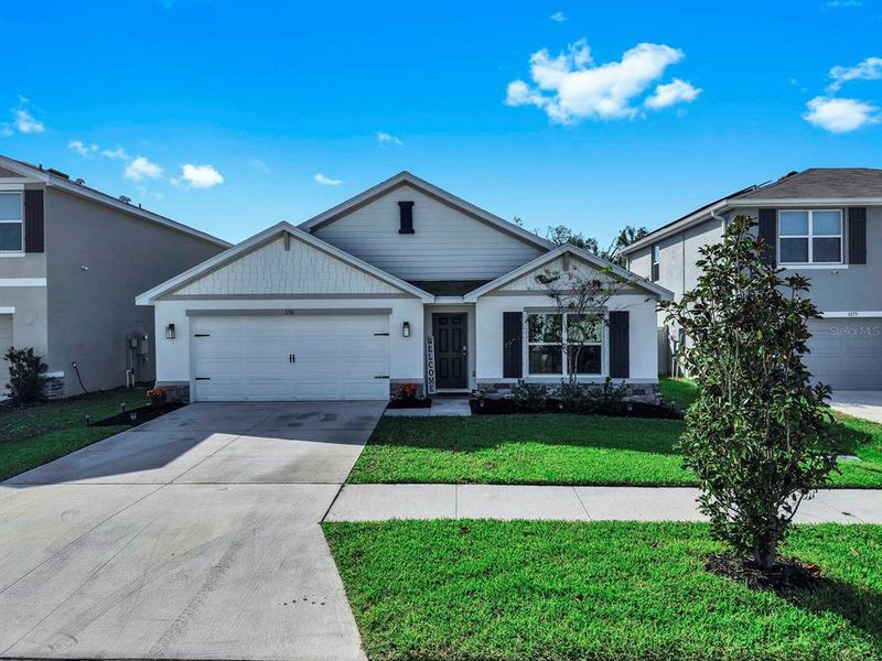 Front exterior of a new home in Berry Bay, Wimauma, FL, highlighting curb appeal (Image 2). Front exterior of a new home in Berry Bay, Wimauma, FL, highlighting curb appeal (Image 2).