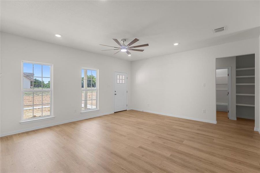 Unfurnished living room featuring light wood-style floors, recessed lighting, and a ceiling fan