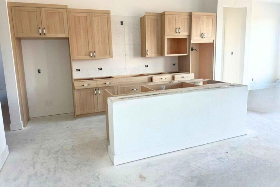 Kitchen with a kitchen island and light brown cabinets