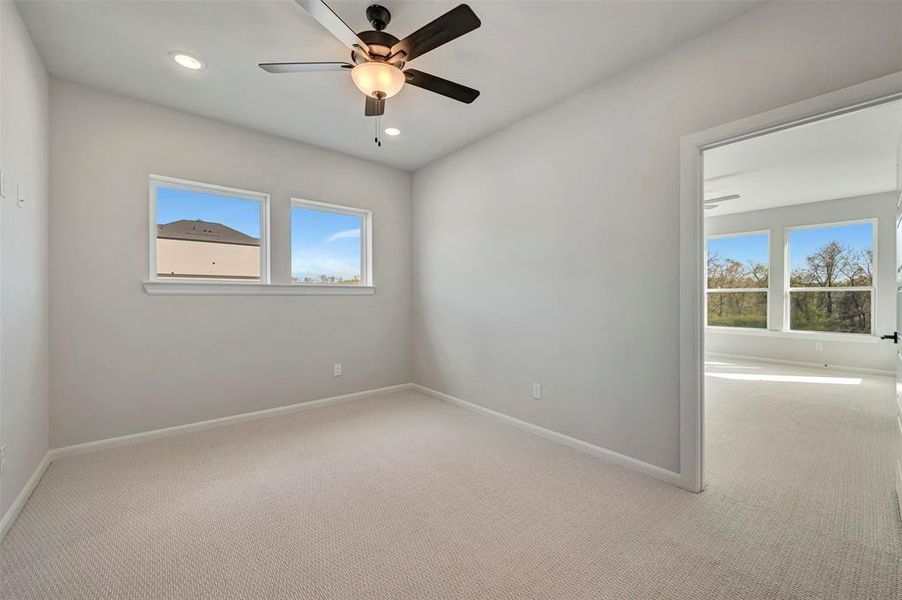 Empty room featuring light colored carpet, recessed lighting, and a ceiling fan Empty room featuring light colored carpet, recessed lighting, and a ceiling fan