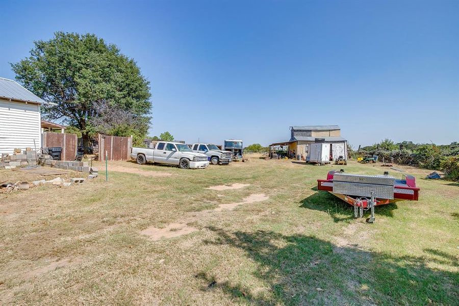 View of green lawn with an outbuilding View of green lawn with an outbuilding