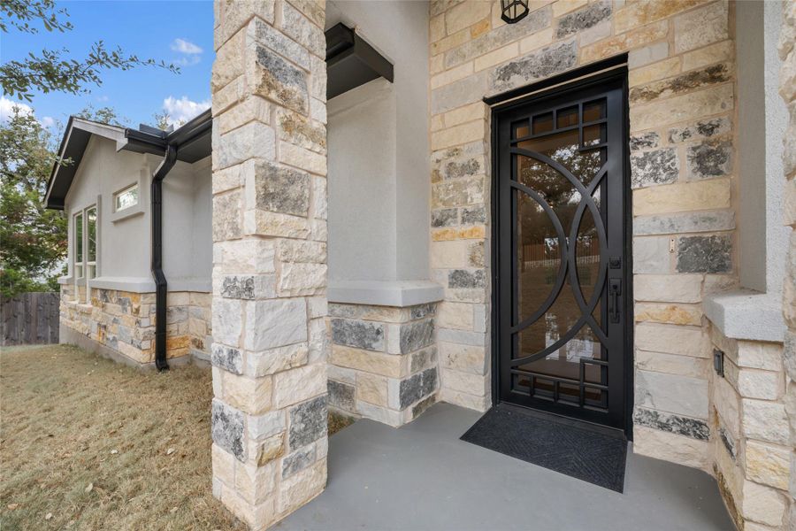 View of exterior entry with stone siding