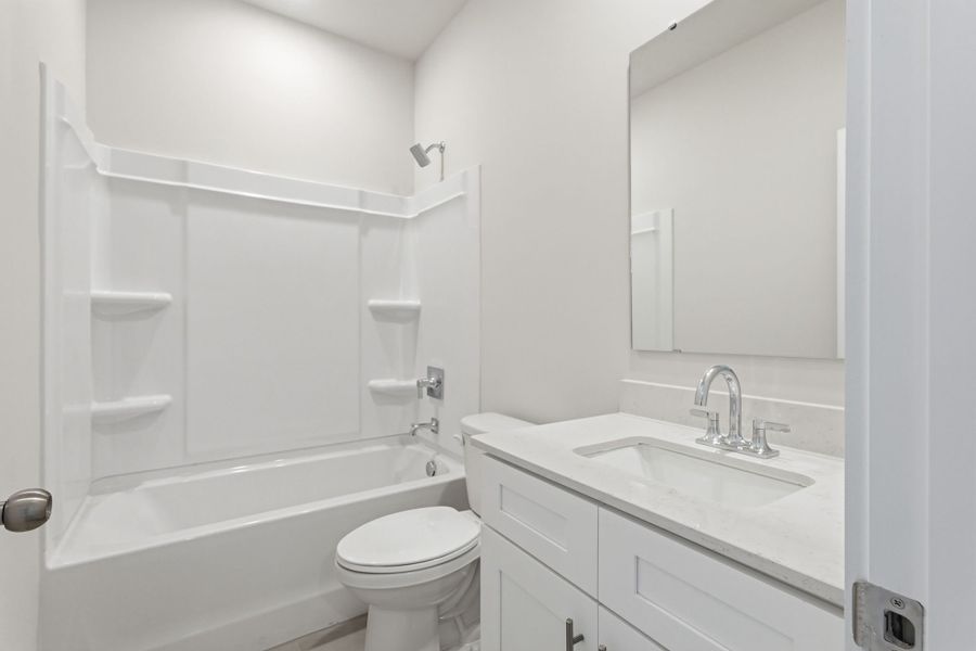 A bathroom with a sink toilet and bathtub.