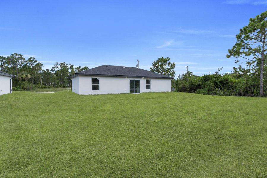 Front exterior of a new home in , Lehigh Acres, FL, highlighting curb appeal (Image 15).