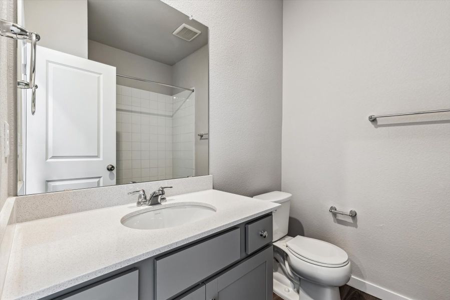 A bathroom with a sink and toilet.