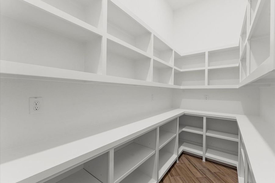 Disguised with a cabinet-style door, the hidden pantry opens to a huge walk-in storage space—ideal for organization and convenience. Disguised with a cabinet-style door, the hidden pantry opens to a huge walk-in storage space—ideal for organization and convenience.